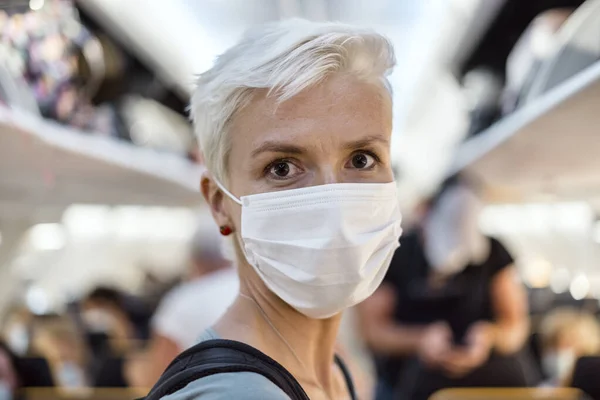 フェイスマスクを着用して飛行機に立つ女性 — ストック写真
