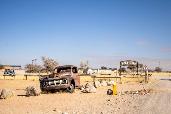 Solitaires car graveyard in Namibia - 27 August, 2025: features rusted vintage cars near small desert buildings, set against dunes and mountains, capturing desert charm and isolation.