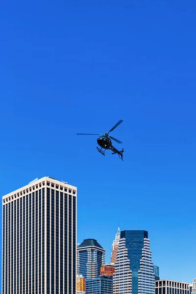 Helicopter above Lower Manhattan, New York, USA. Skyscrapers on the background