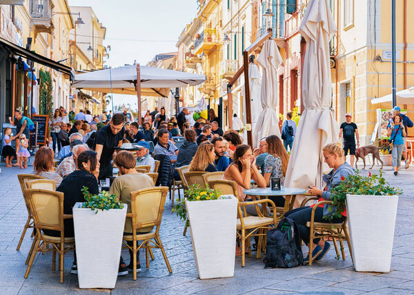 Olbia, Italy - September 11, 2017: Tourists at street cafe on Corso Umberto Street in Olbia, Sardinia, Italy