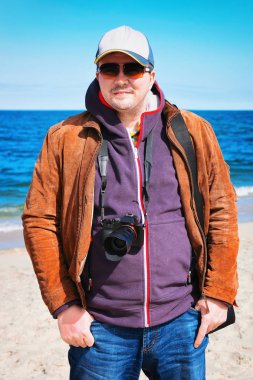 Sandy Hook, NJ okyanus sahilinde rüzgarlı hava, dijital fotoğraf makinesi olan adam