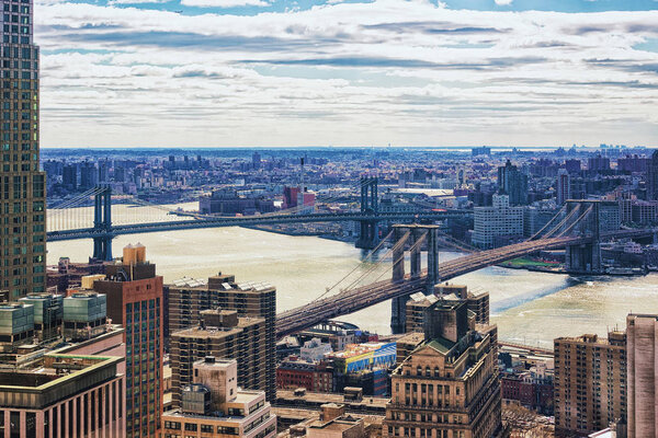 Aerial view on Lower Manhattan, New York, Brooklyn Bridge and Manhattan Bridge over East River, the USA. Skyline with skyscrapers. Brooklyn Heights on the background.
