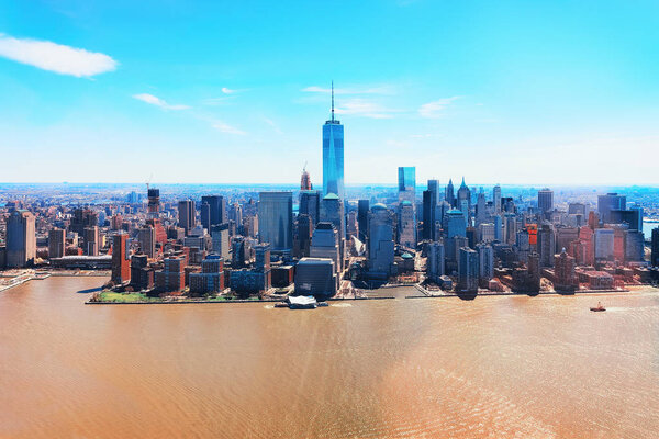 Manhattan downtown panorama and East River with urban skyscrapers and blue sky in New York City, USA