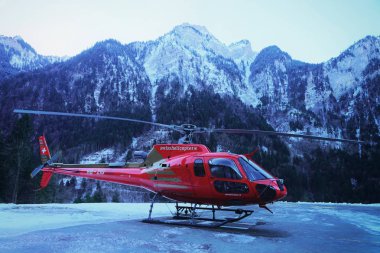 Gsteigwiler, İsviçre - 31 Aralık 2013: Kırmızı helikopter İsviçre Alpleri heliport kışın, Gsteigwiler, İsviçre