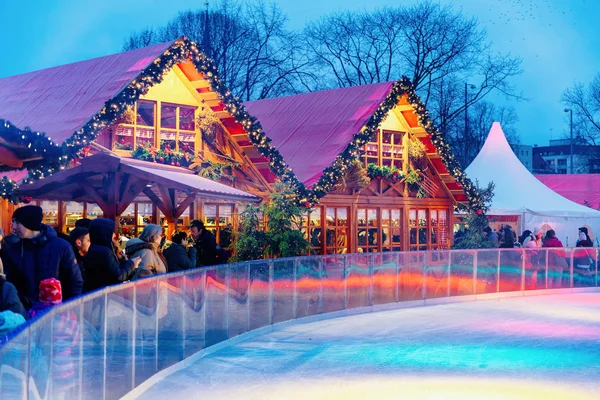 stock image Berlin, Germany - December 10, 2017: People on Ice skating Rink at Night Christmas Market at Town Hall in Winter Berlin, Germany. Advent Fair Decoration and Stalls with Crafts Items on the Bazaar.