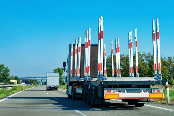 Truck without trailer box at the highway asphalt road in Poland. Truck transporter