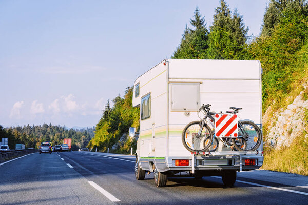 Camper rv abd bike on the road in Slovenia
.