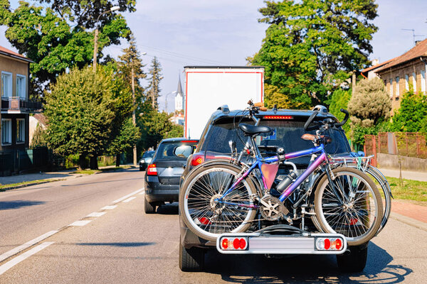 Car with bicycles on the road in Poland.
