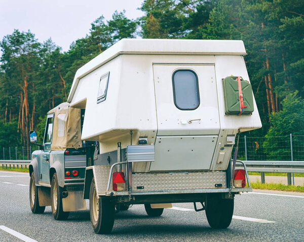 Car with camper wagon on the road in Warsaw in Poland