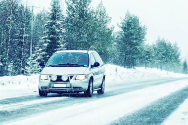 Car in the winter road at Rovaniemi in Lapland, Finland