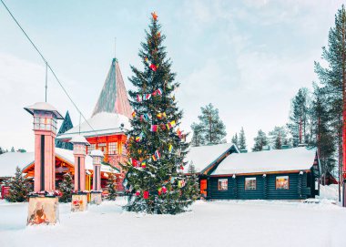 Christmas tree and Santa Claus Village in Rovaniemi in Lapland in Finland. clipart