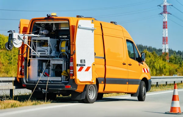 Mini van with cable to do road works in Poland.