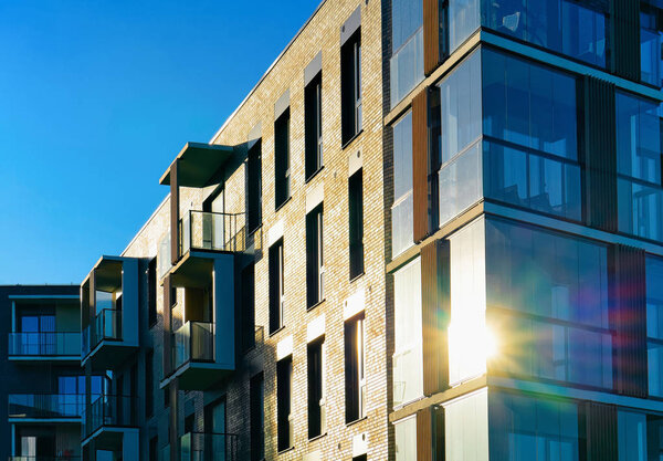 Modern apartment building flat exterior concept. Sunshine sun flare