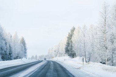 Kış yol ve Snowy Orman soğuk Lapland Finland.