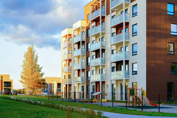 New apartment house and home building complex concept. Street with a children playground.