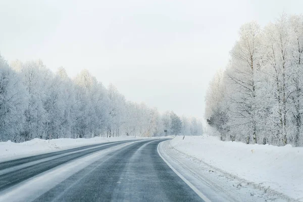 Winter road and a Snowy Forest at Cold Finland of Lapland.