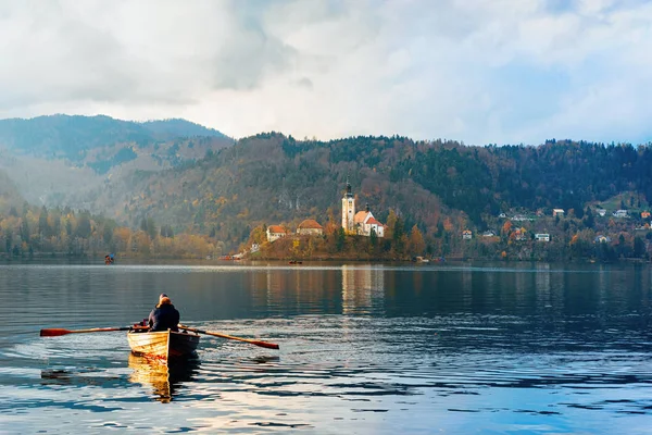Beautiful landscape with people in boat in Bled Lake