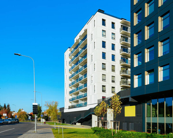 Apartment house residential building with cars parked in street