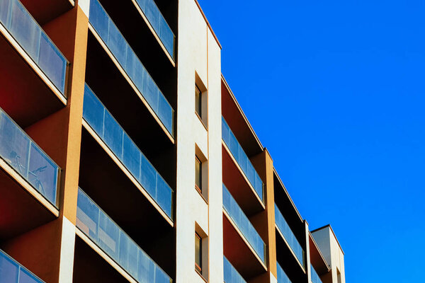 Residential apartment house facade with an empty place for the copy space. Blue sky on the background.