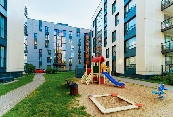 Modern residential apartment flat house building and children playground