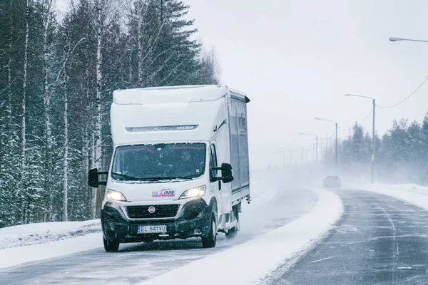 Mini van in the Snowy Winter Road Finland Lapland EU