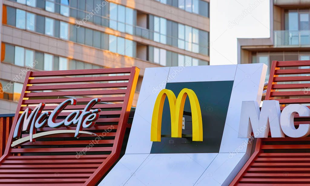 Vilnius, Lithuania - October 6, 2018: Mcdonald and Mccafe logo on the roof of the restaurant.