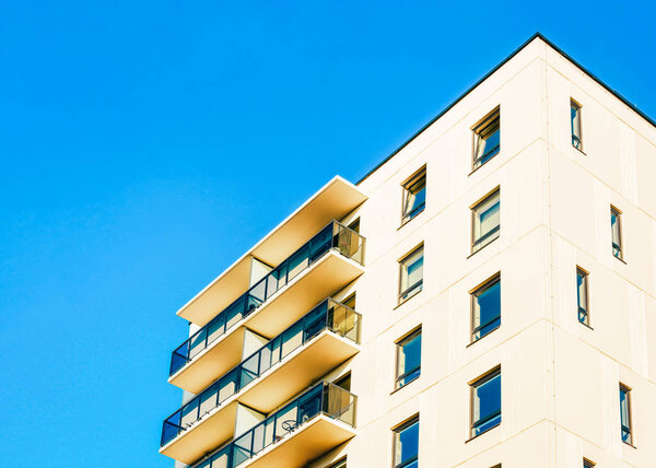 Residential EU apartment house facade with an blank copy space. Blue sky on the background.