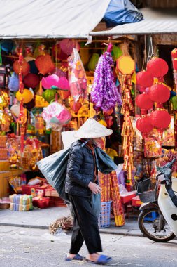 Satıcı kadın sokak pazarında Geleneksel Vietnam şapka giyer H