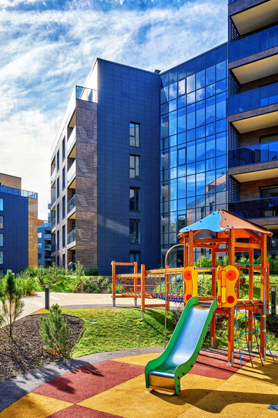 Modern complex of residential buildings and children playground