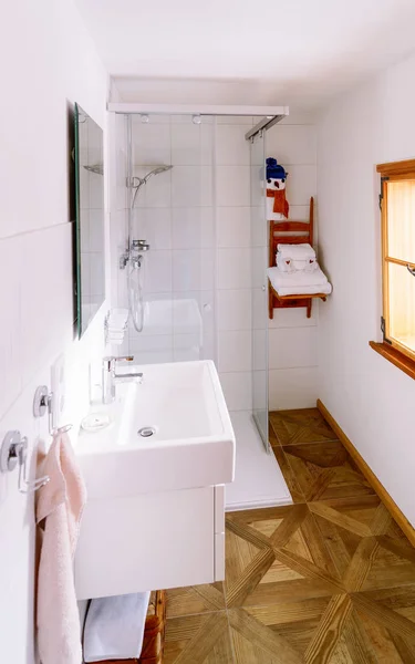 Interior in modern white bathroom with wood design sink shower