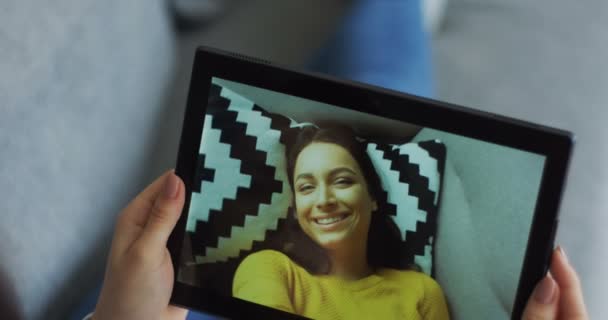 Femme caucasienne vidéochat sur la webcam de la tablette et souriant. Gros plan de l'appareil dans les mains des femmes . — Video