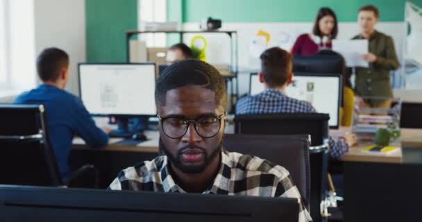 Retrato de jóvenes afroamericanos trabajando en el proyecto y regocijándose en el éxito mientras están sentados en el cargo. Trabajador de oficina. — Vídeos de Stock