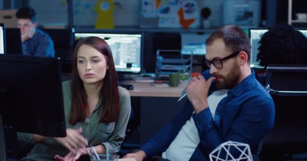 Dos empleados sentados en la computadora y discutiendo temas del proyecto. Hermosa mujer en la oficina sacude la cabeza en la negación. Lluvia de ideas en parejas. — Vídeos de Stock