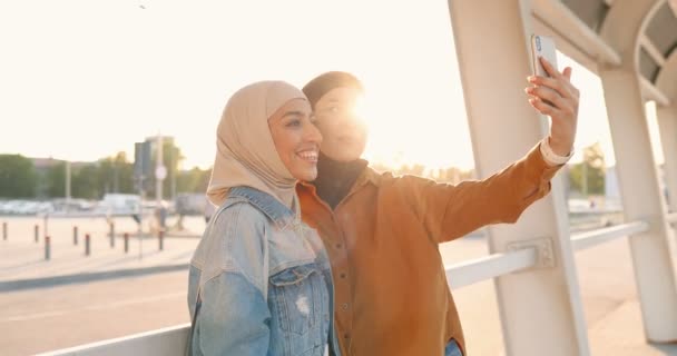 Δύο Όμορφες Νεαρές Άραβες Μαντίλες Χαμογελούν Και Βγάζουν Φωτογραφίες Σέλφι — Αρχείο Βίντεο