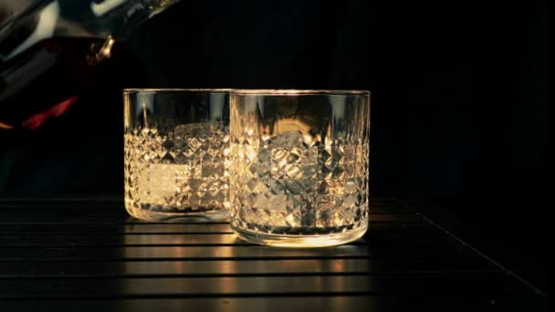 Barman Pouring Whiskey Two Glasses Ice Cubes Wood Table Black — Stock Video