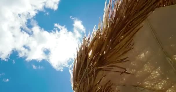 Sonnenschirm Aus Stroh Unter Blauem Himmel Bewegung Auf Wind Sommerferienreservierung — Stockvideo