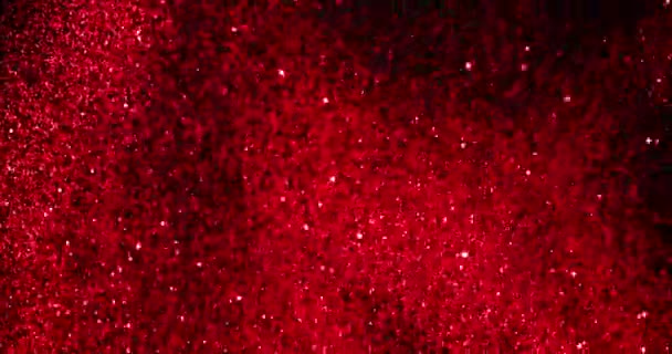 Weihnachten Roter Gradient Funkelt Glitzerexplosion Staubpartikel Von Oben Auf Schwarzem — Stockvideo