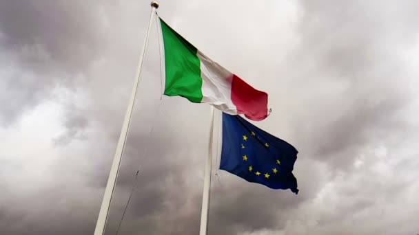 Waving fabric texture of the flag of italy and union europe on sky with clouds, concept of — Stock Video