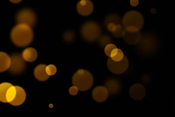 Natal brilho dourado brilho fundo com bokeh no preto , — Fotografia de Stock