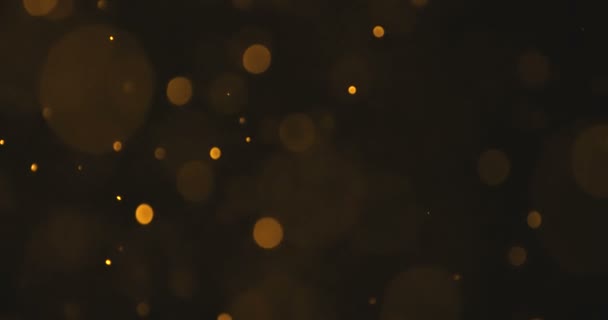 Abstrato ouro brilho partículas bokeh fluindo efeito sobre fundo preto, feriado feliz ano novo — Vídeo de Stock