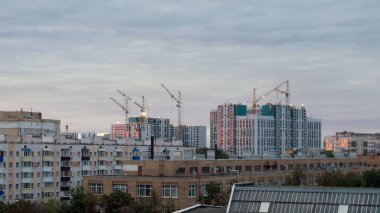 Günbatımında kuş gözü olan bir inşaat alanı. Drone 'la video çekimi. Kule vinci, kazıcı ve kum.