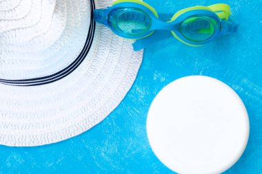 Creative layout with copy space, sunglasses and sunscreen or suntan lotion. Minimal summer vacation concept. Flat lay.