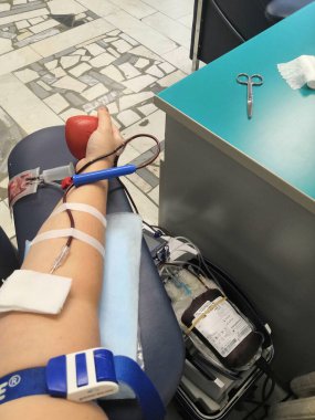 Blood donor at donation with a bouncy ball holding in hand.Also concept image for World blood donor day-June 14. concept life, blood, giving