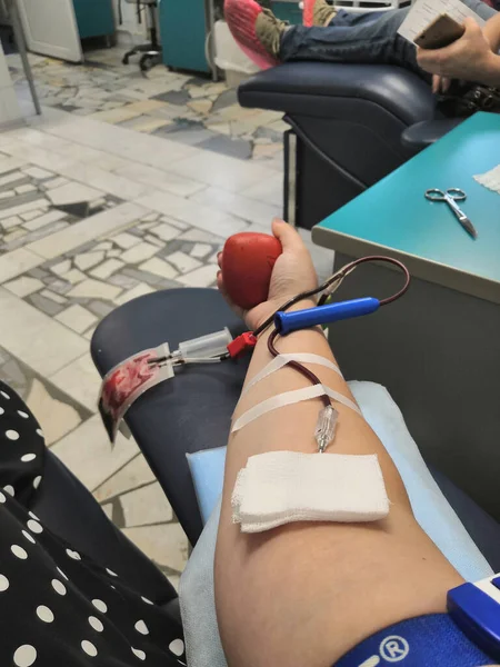 Blood donor at donation with a bouncy ball holding in hand.Also concept image for World blood donor day-June 14. concept life, blood, giving
