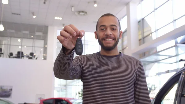 Man shows car key at the dealership