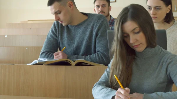 Students write in their exercise books — Stock Photo, Image