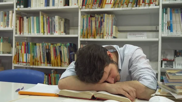 Guy sleeps at the library