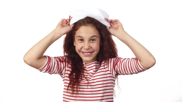 The happy girl trying on a Santa Claus hat — Stock Photo, Image