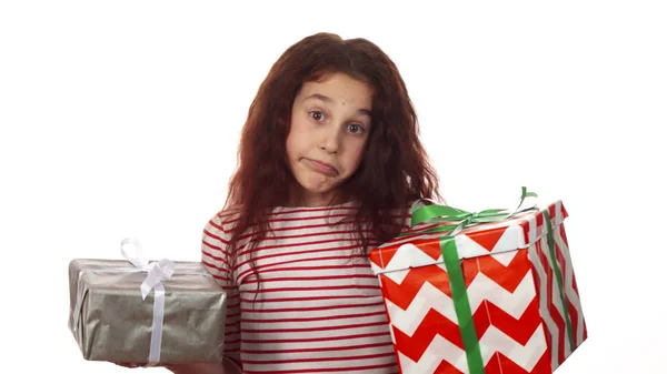 Przemyślane dziewczyna patrzy na jej dwa prezenty i wybiera spośród nich — Zdjęcie stockowe