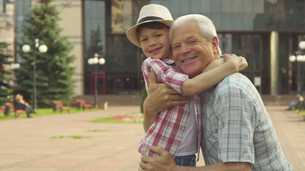 Senior man hugs his grandson — Stock Photo, Image